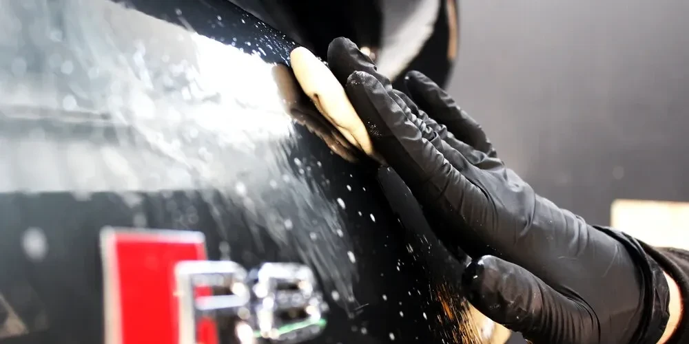 Clay bar decontamination being applied to car paint